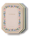 Set of notebooks with floral designs on a white background