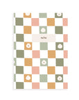 Notebook with a colorful checkered pattern and dumpling icons on a white background