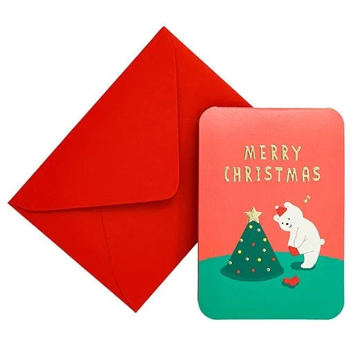 Red envelope and Christmas-themed card with a polar bear and tree illustration on a white background