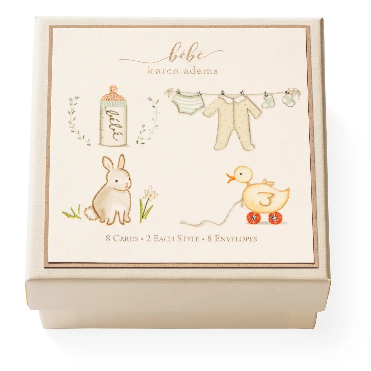 A cream box of mini cards with 4 designs on the cover: baby bottle, clothing, bunny, ducky toy
