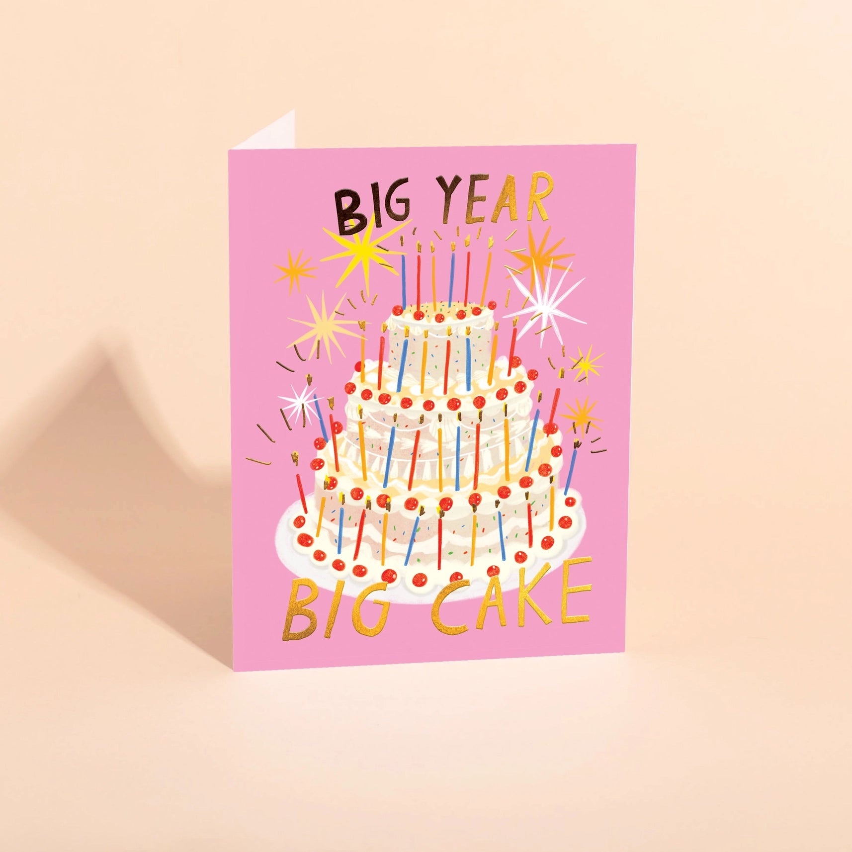 pink birthday card featuring large birthday cake with text "big year, big cake"