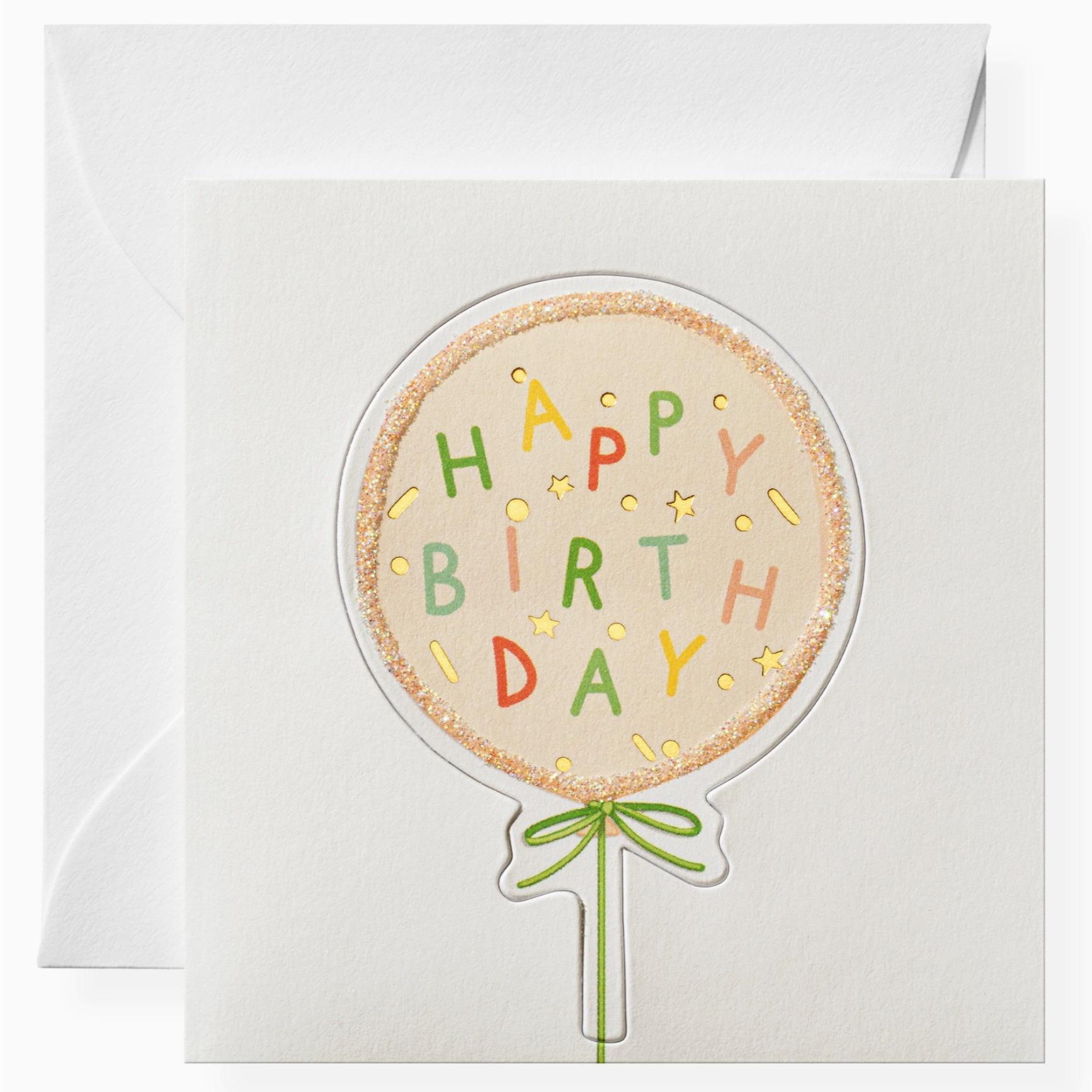 A greeting card with a birthday balloon design and the words 'Happy Birthday' on it, along with a green ribbon design, sent with a white envelope.