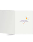 Inside of a white card with a party hat icon and blower and text reading "wishing you a birthday filled with unexpected delights!"