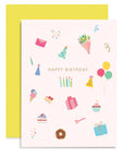 A birthday greeting card with various illustrations like cakes, balloons, and party hats, foil stamped with gold foil, accompanied by a yellow envelope.