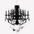 A black paper chandelier with hanging decorations including tassels and various shapes in silver and black colors, designed for Halloween parties.