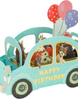 pop up 3d card featuring blue car with dogs inside, "happy birthday" text on the side