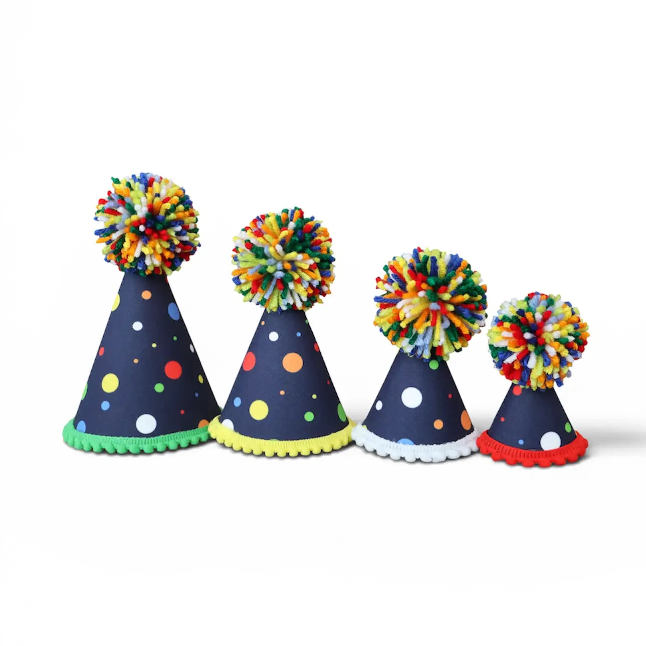 Four navy blue party hats of decreasing sizes lined up on a white background. Each hat features colorful polka dots, a scalloped trim, and a matching multicolor pom-pom on top.