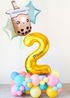 Colorful balloon arrangement with a number '2' and boba tea with star balloons on a white background