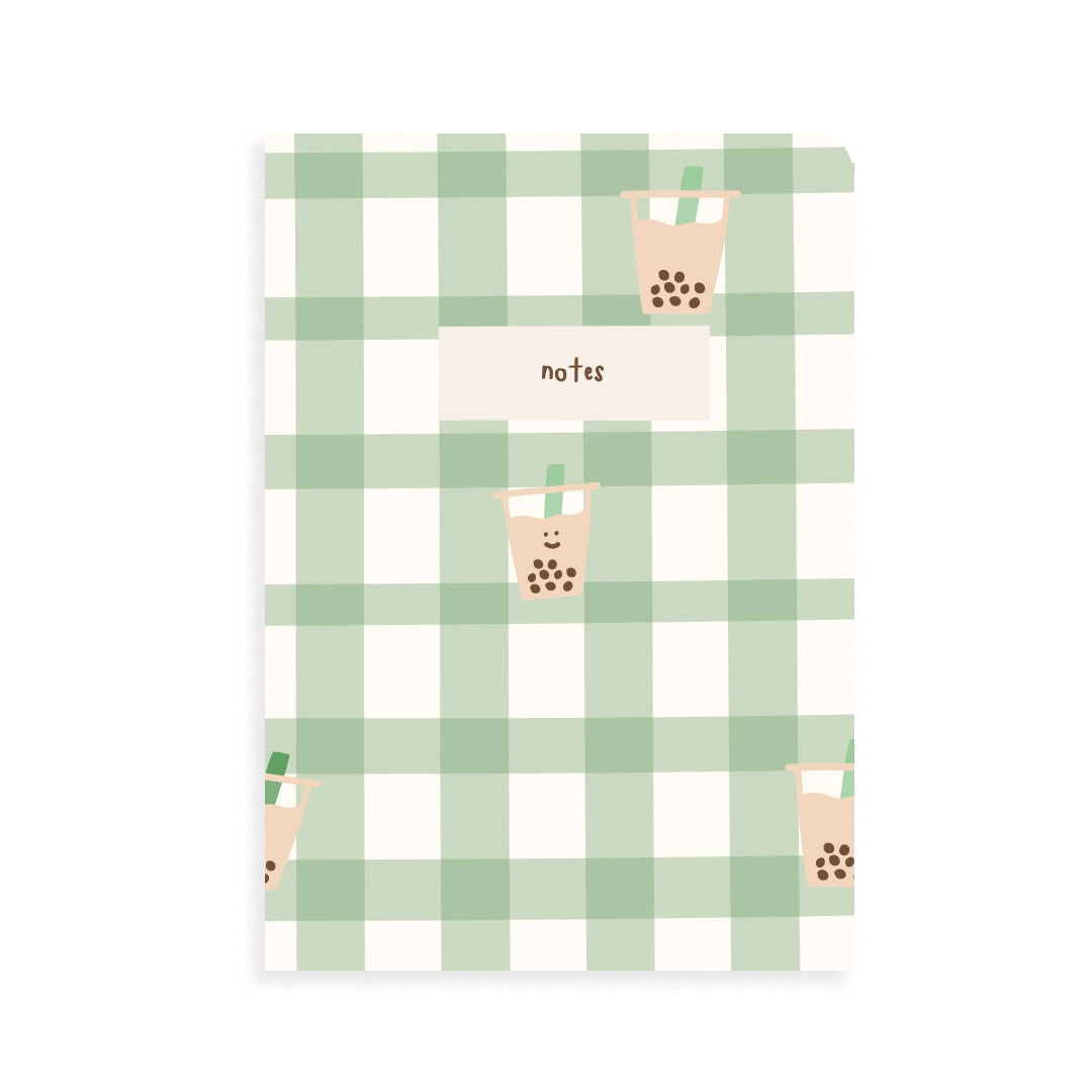 Notebook with green plaid pattern and boba design on a white background