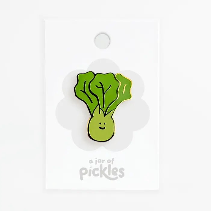 smiley green vegetable pin on white background