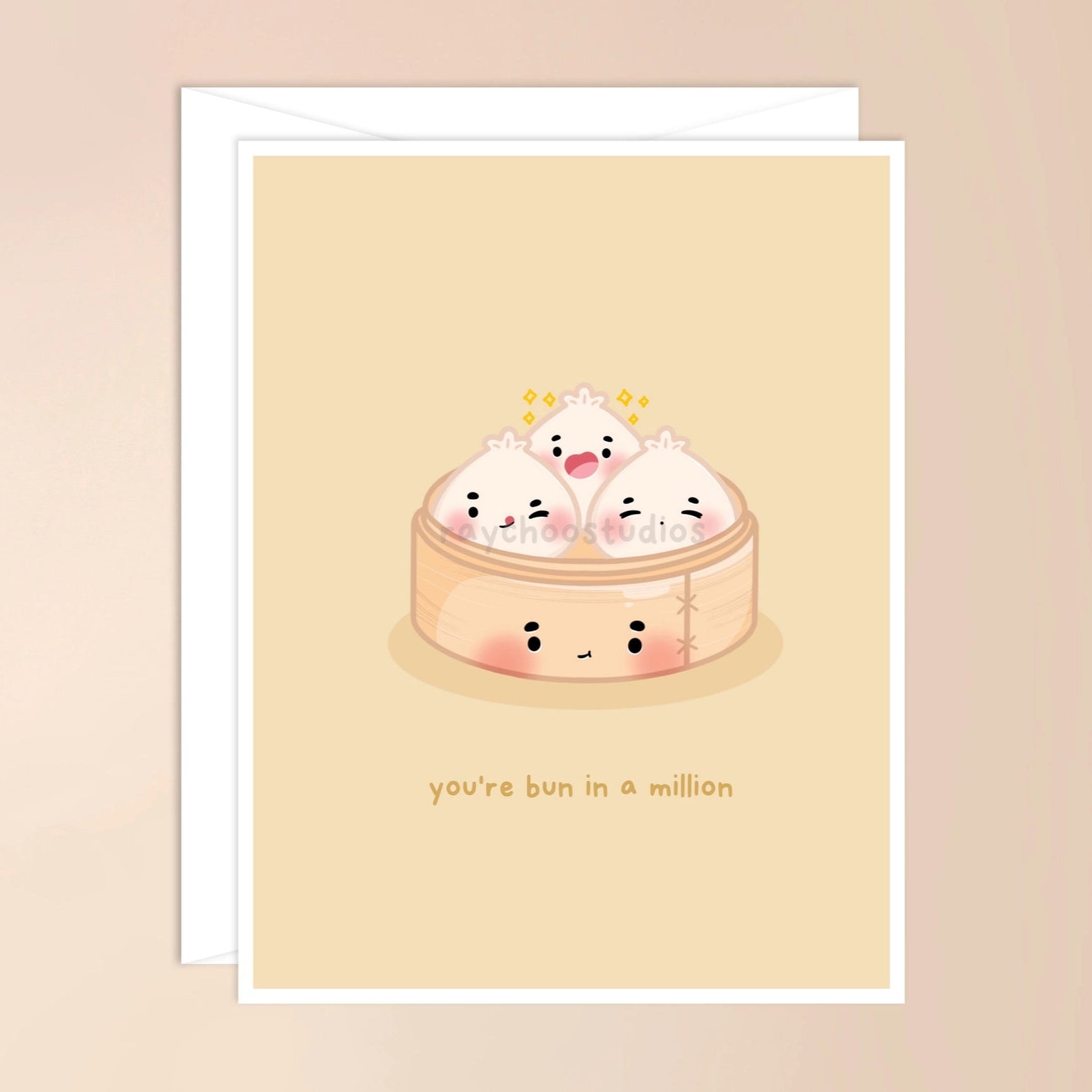 A greeting card with an illustration of cute buns with faces and text that reads 'you're bun in a million'.