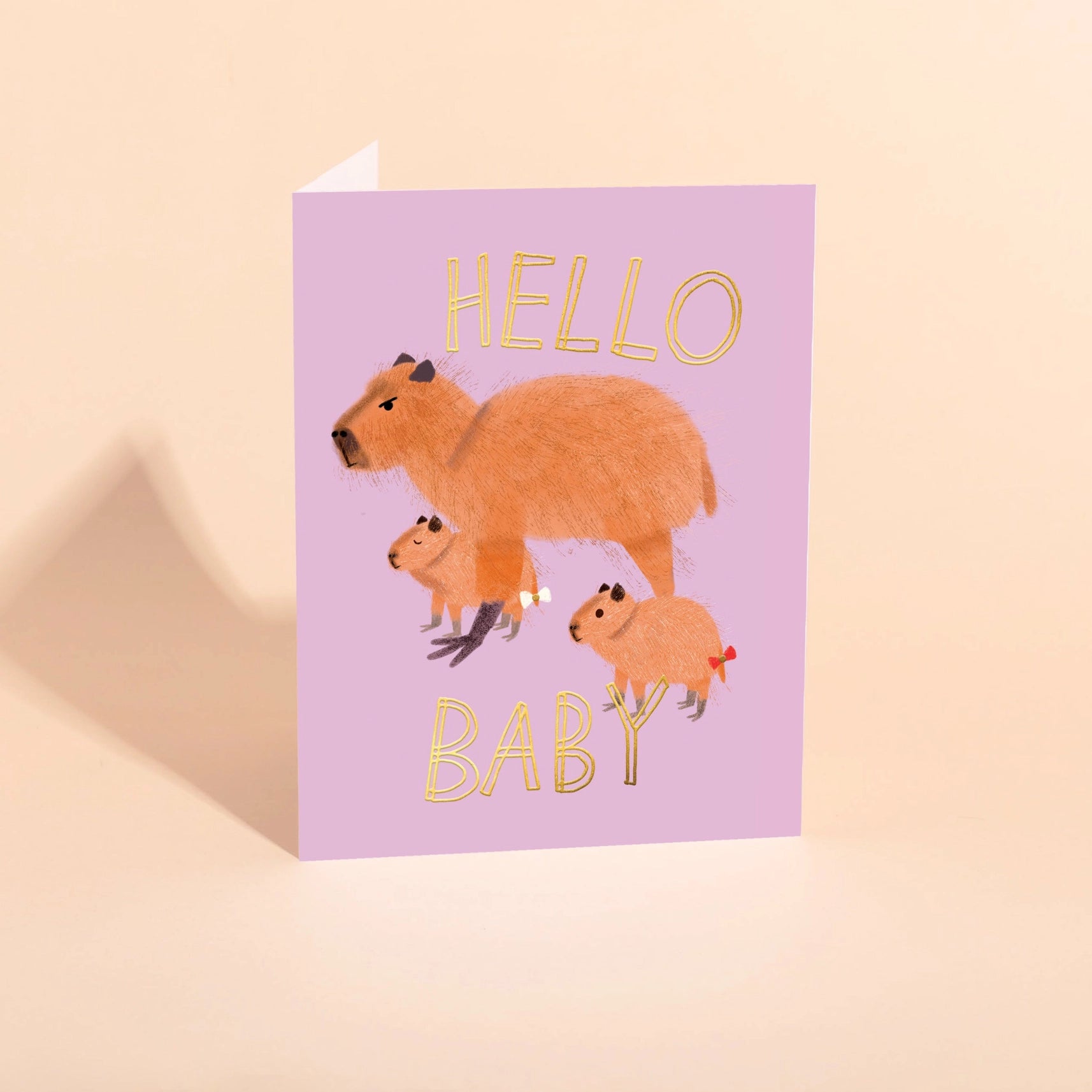 purple card with 3 capybaras and text "Hello Baby"