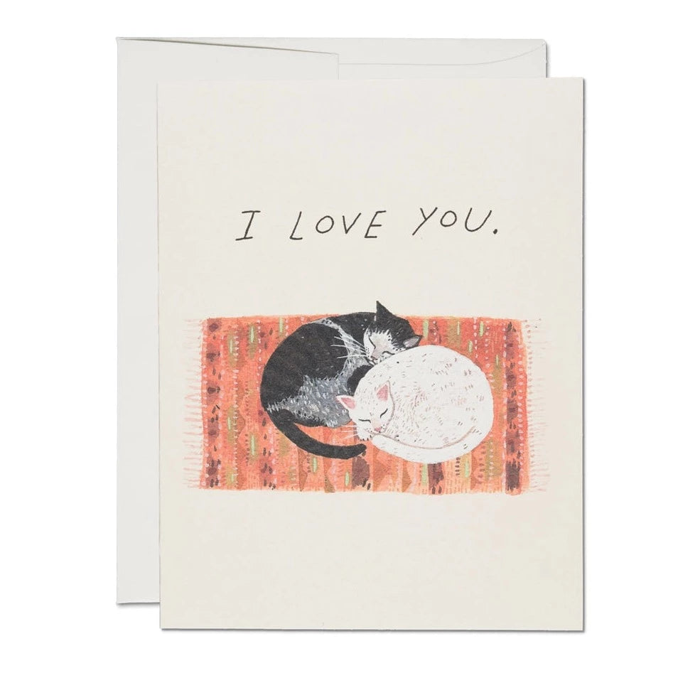 A greeting card with an illustration of two cats cuddling, with the text 'I love you.' on the front.