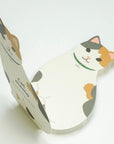 Cat-shaped notepad on a white background