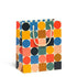 A medium-sized, multicolored geometric pattern gift bag with white cotton rope handles.