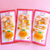 Three packaged sets of cute orange-themed hair accessories on a pink background.