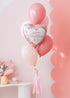 A balloon bouquet featuring an opal heart-shaped balloon with soft pink latex balloons, tied with a bow and tassel.