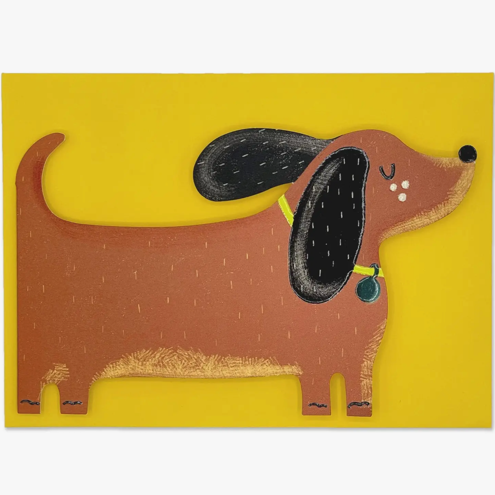 A greeting card shaped like a dachshund with floppy ears, on a yellow background.