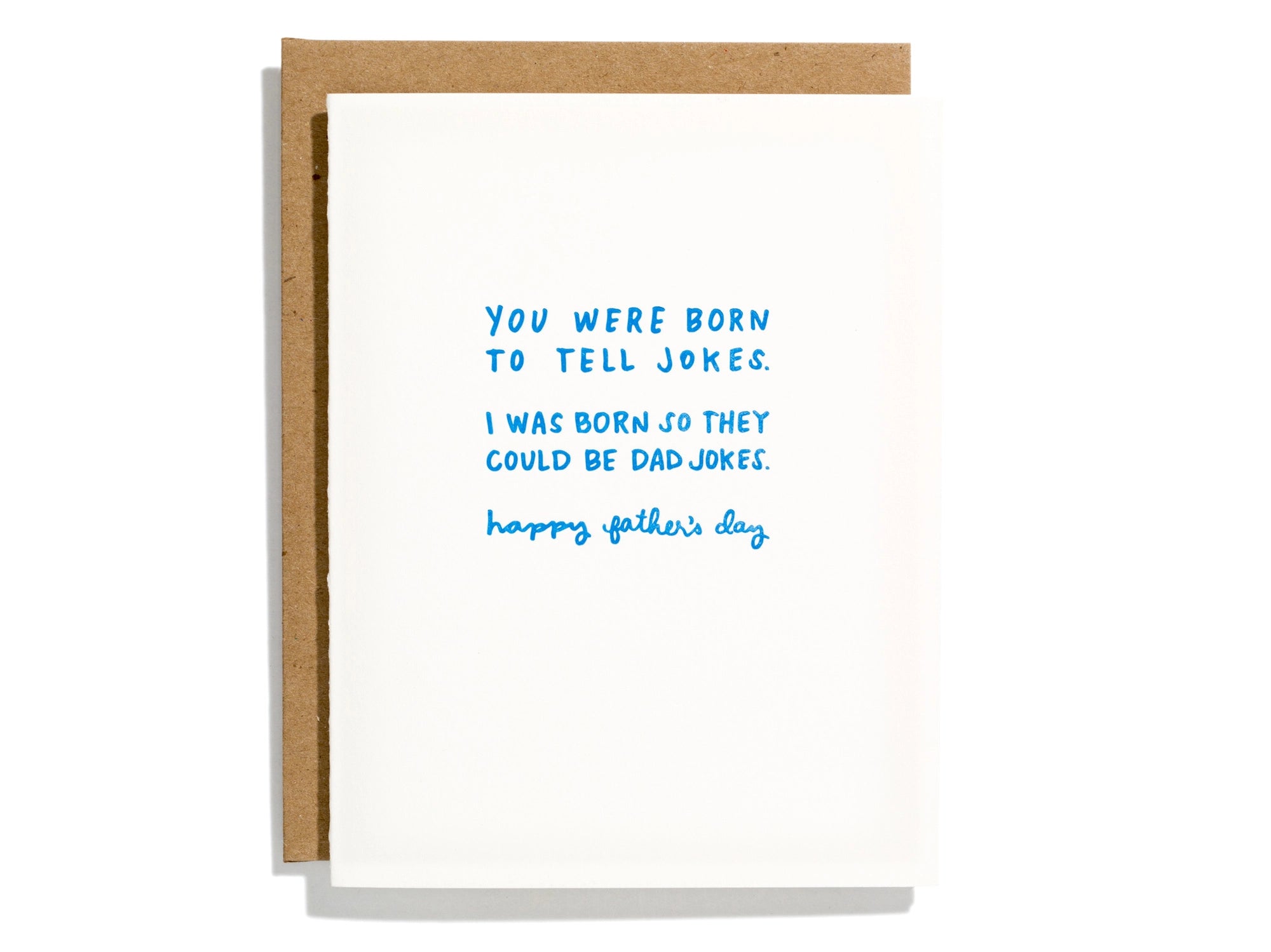 A greeting card with a blue and white design, featuring text that reads 'You were born to tell jokes. I was born so they could be dad jokes.