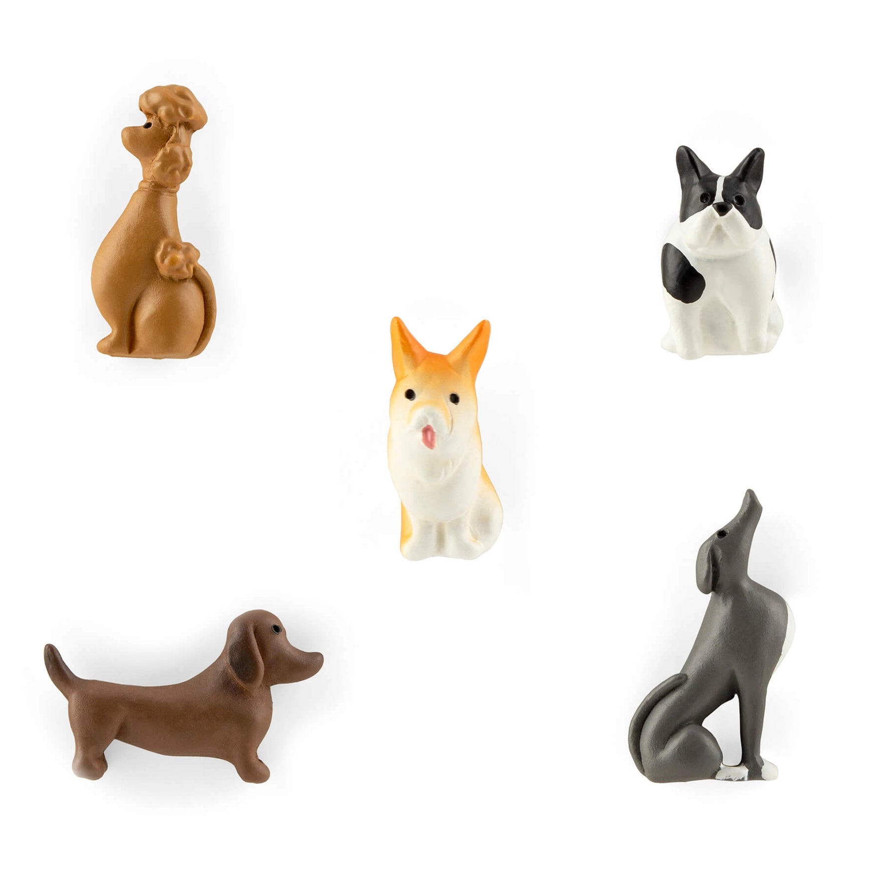 Set of five dog figurines in various poses on a white background