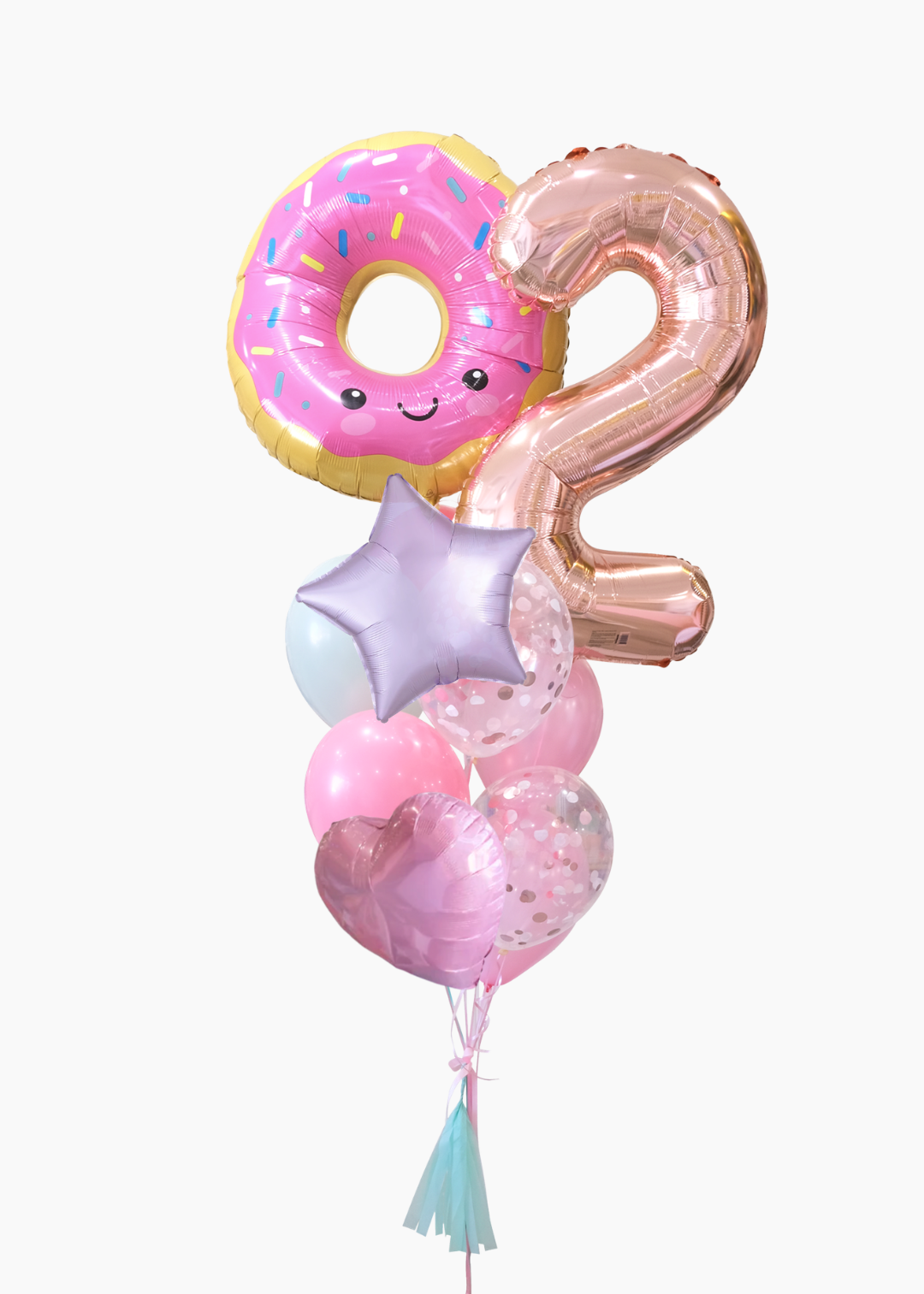A cluster of birthday balloons on a white background, featuring a pink donut balloon with a smiling face, a metallic rose gold number 2 balloon, a lavender star balloon, and pink heart balloons with confetti.