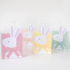 set of four pastel color favor bags with bunny wearing a bow