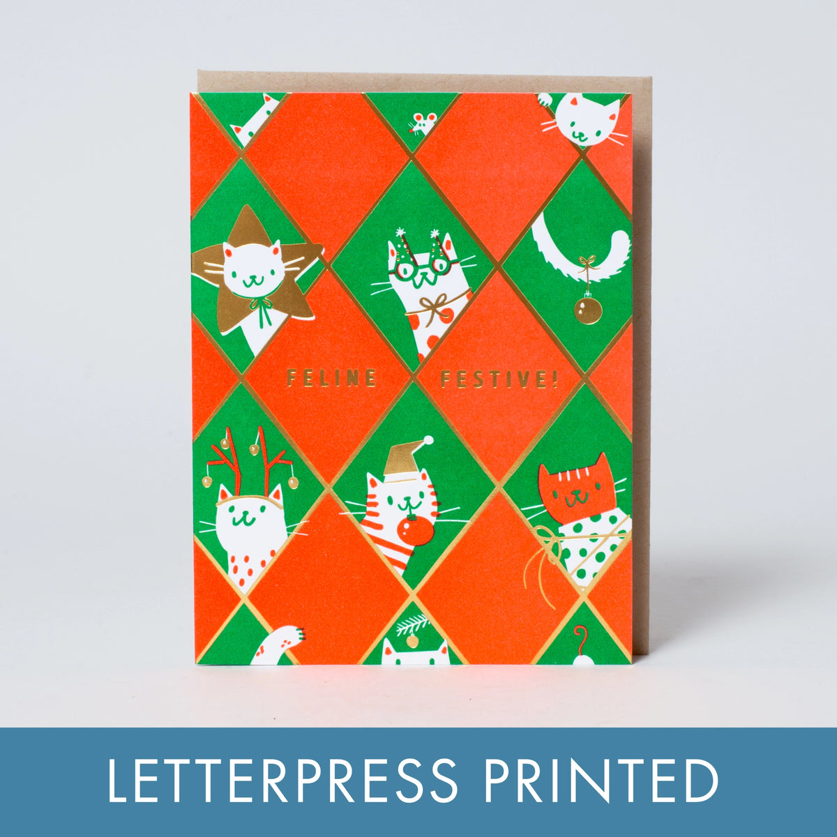 A green and red greeting card with cats dressed up in festive fits.