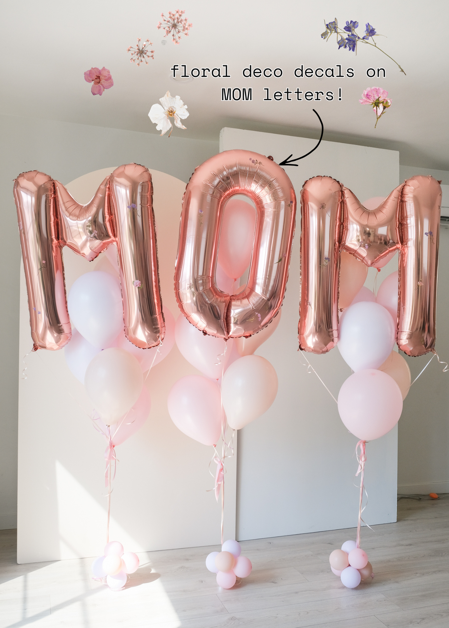 Rose gold letter balloons reading "MOM" with floral decals
