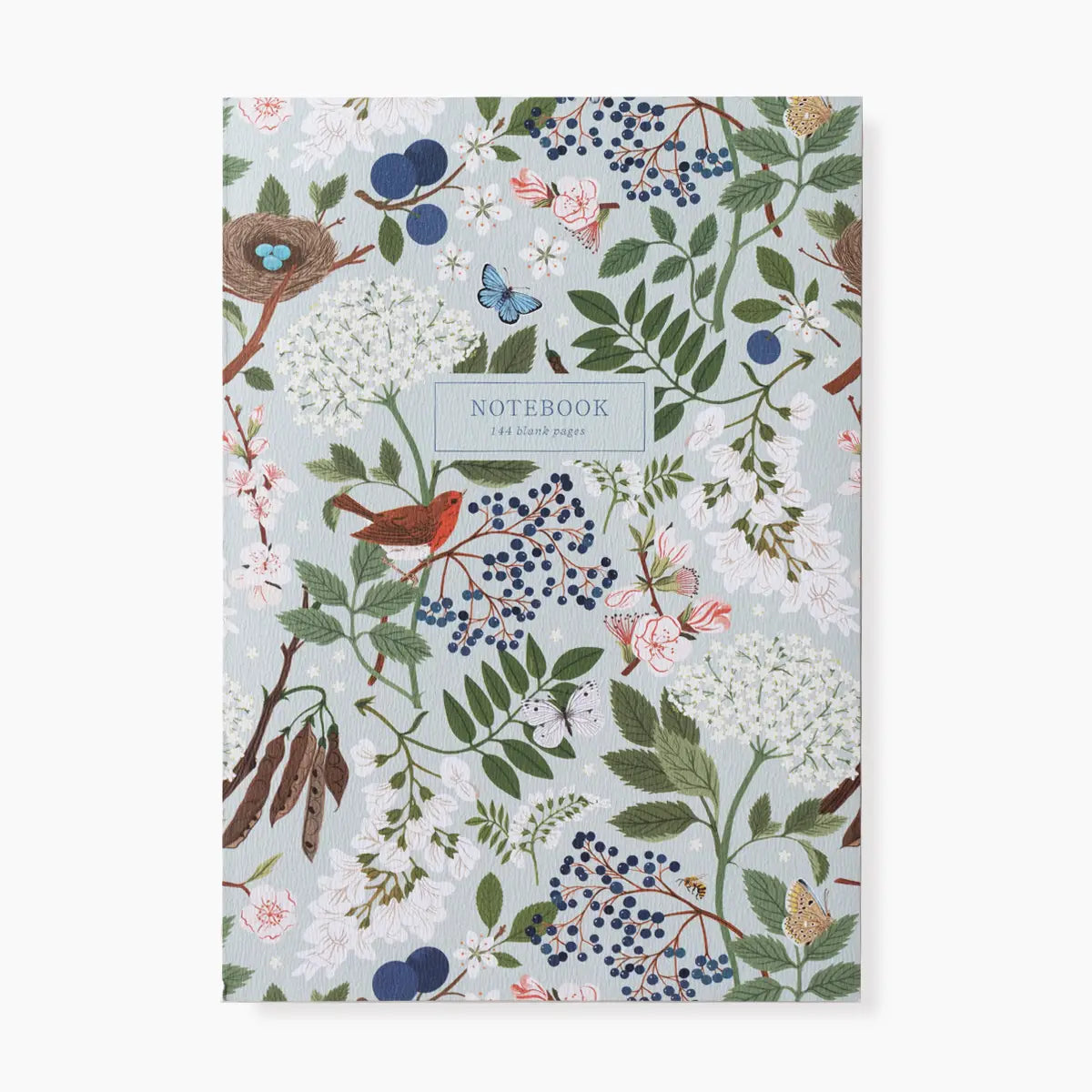 A notebook with a detailed botanical and bird pattern on a pale blue-gray background, featuring green leaves, white flowers, blue berries, pink blossoms, and a red bird. The center label reads 'NOTEBOOK' with '180 blank pages' underneath.