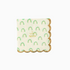 A paper napkin with a rainbow and scallop design featuring gold foil accents.