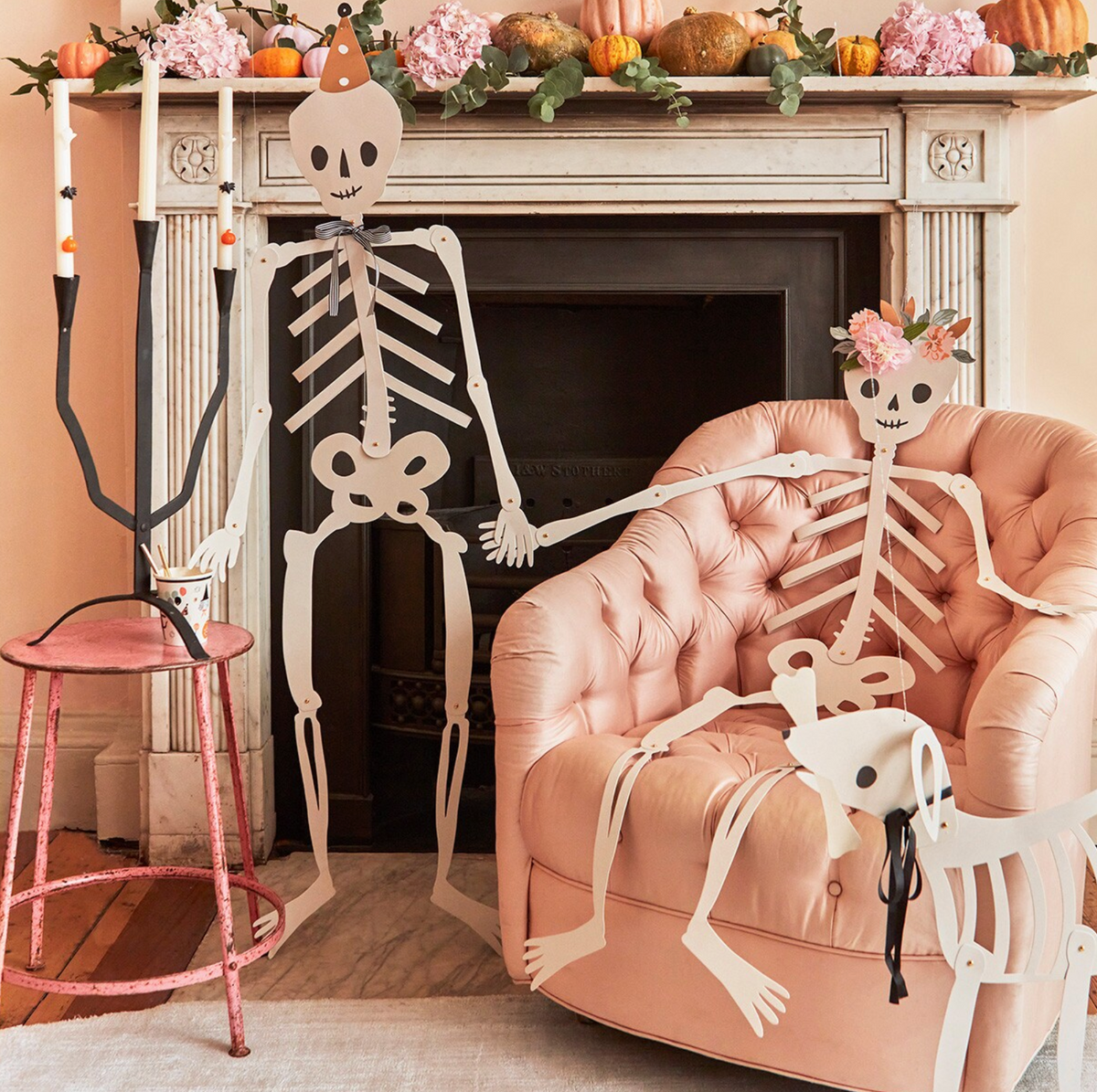 Decorative skeletons in a living room with Halloween decorations.