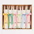 A set of six Easter-themed bunny crackers in a box, featuring gingham ribbons and tissue paper hats in various colors.