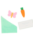 A collection of small favors found inside the bunny crakcer of an eraser, joke and oragami