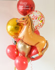 A balloon bouquet for year of the horse, with red, gold, and confetti balloons