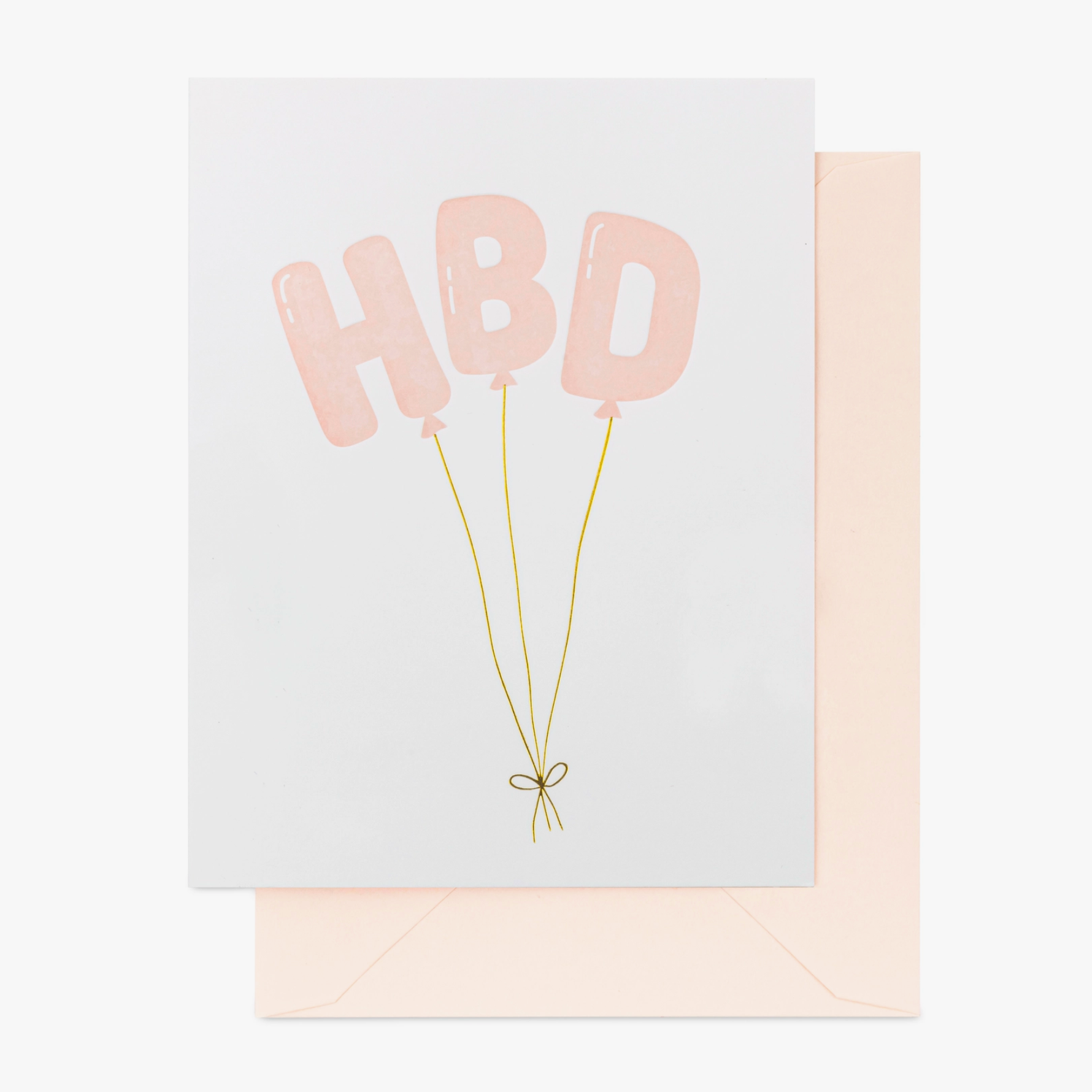 A greeting card with 'HBD' written on it, featuring pink balloon illustrations and gold foil details, accompanied by a matching envelope.