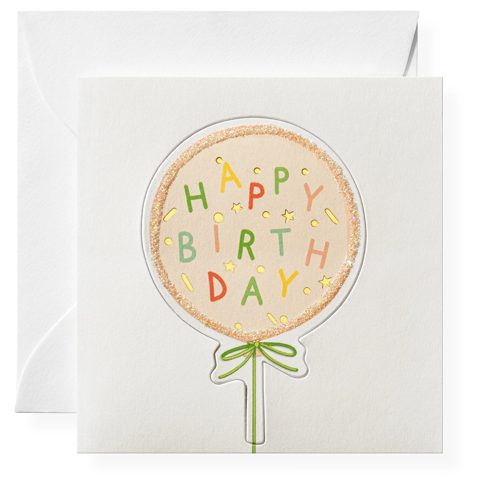 A greeting card with a hand-glittered, circular balloon design with the words 'Happy Birthday' in colorful letters, attached to a blank card with a green ribbon.