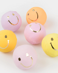 A set of 6 surprise balls with happy faces on them in fun colors
