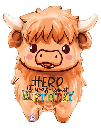 Cute cartoon Highland cow balloon with 'Herd it was your Birthday' text on a white background