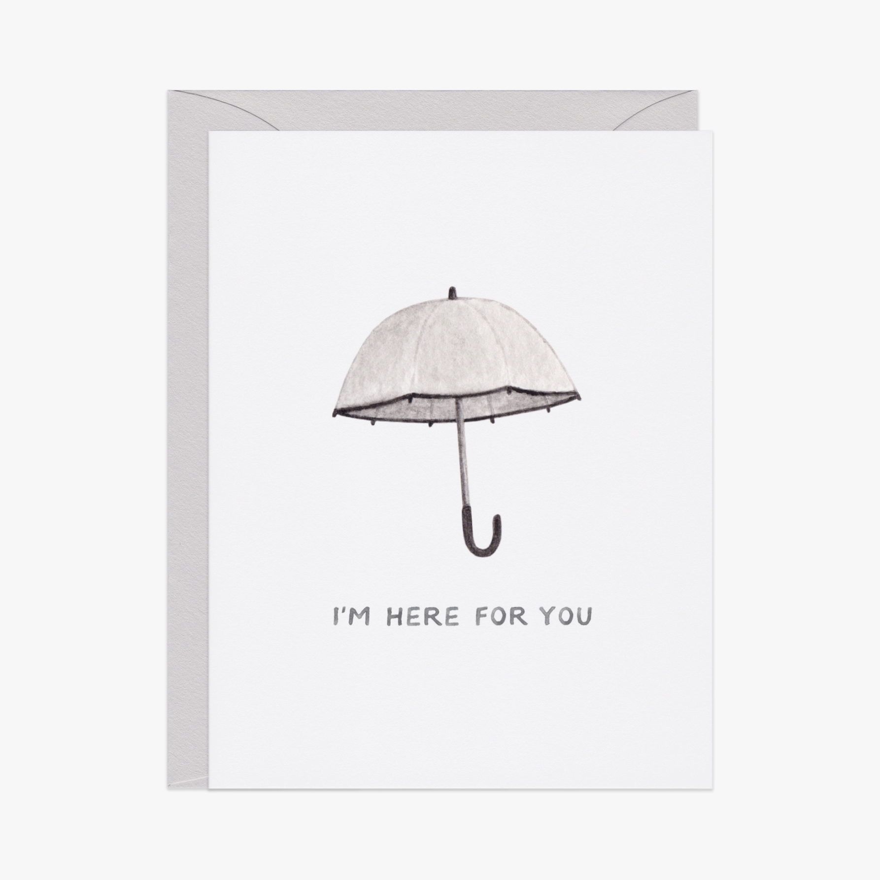 A white greeting card with an illustration of a gray umbrella and the text 'I'm here for you' on the front, paired with a matching envelope.