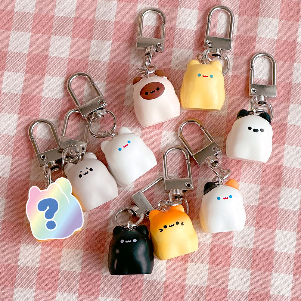 Set of cute keychains on a pink checkered background