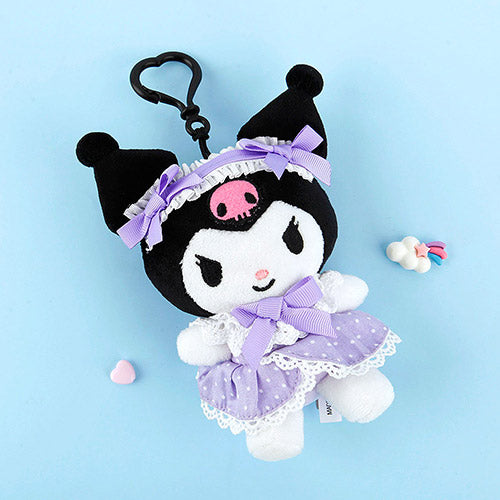 Plush keychain with black hair, purple outfit, and skull design on a light blue background