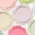 Decorative plates with gold embellishments in pastel colors on a white background