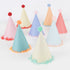 Colorful party hats with pom-pom decorations on a white background