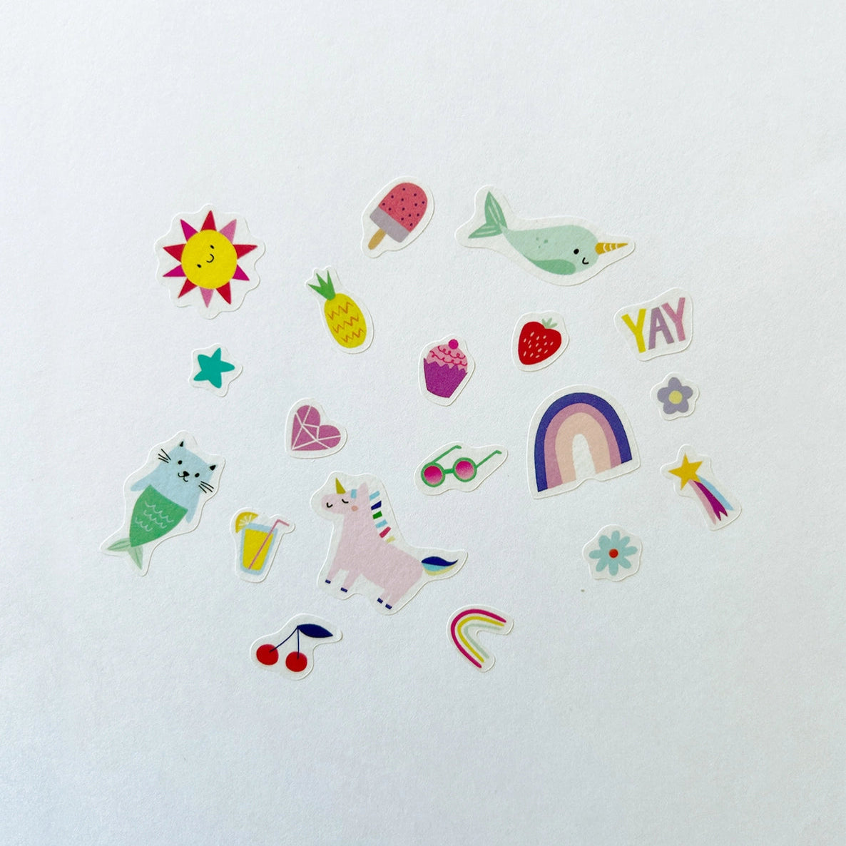 A variety of rainbow themed stickers on a white background