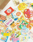 Collection of colorful grocery store labels and packaging on a white surface
