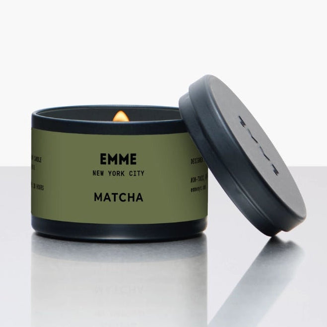 Green candle tin with lid on a white background