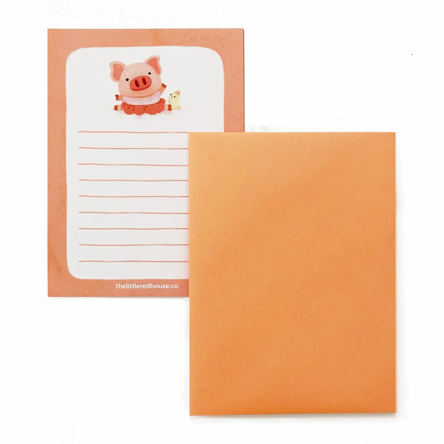 Notepad with a cartoon pig design on an orange cover