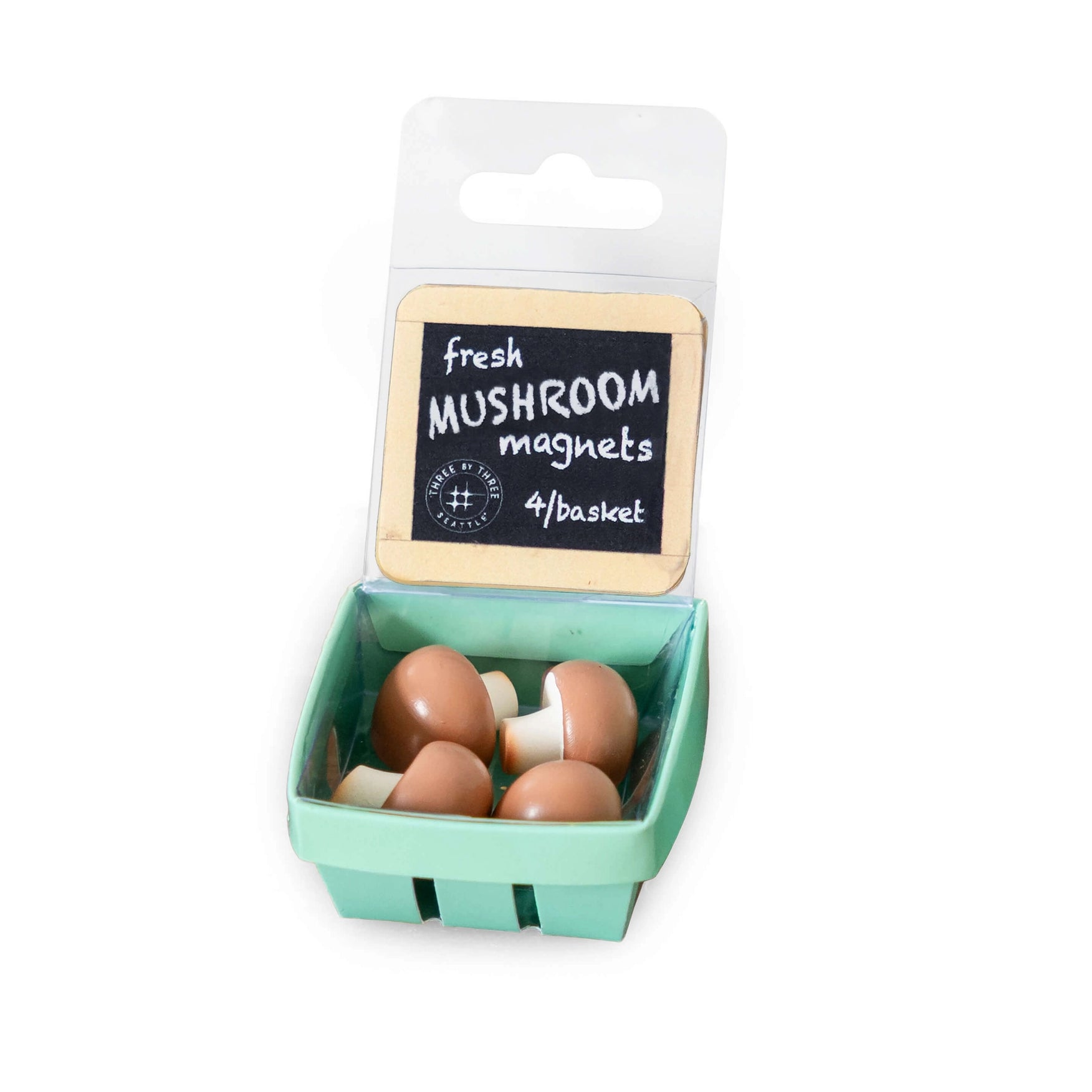 Mushroom-shaped magnets in a packaging resembling a green basket with a label.