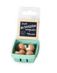 Mushroom-shaped magnets in a packaging resembling a green basket with a label.