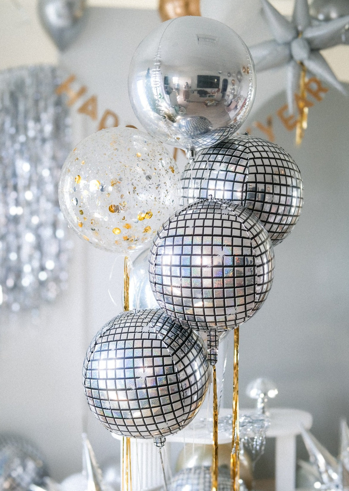 a set of round metallic balloons in silver, disco and confetti